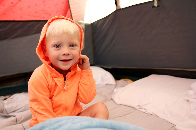 Young Child Waking up in Tent after Camping